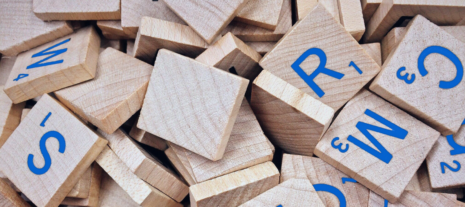 A collection of Scrabble-style wooden letters to signify language data.