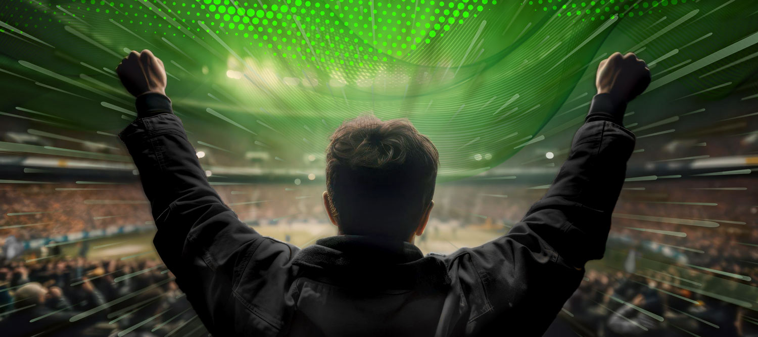 A fan wearing black with their hands in the air looking into a stadium to represent fan experience.